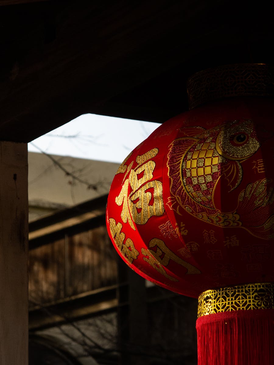 A vibrant red Chinese lantern with golden patterns captured outdoors in Hsinchu County, Taiwan.